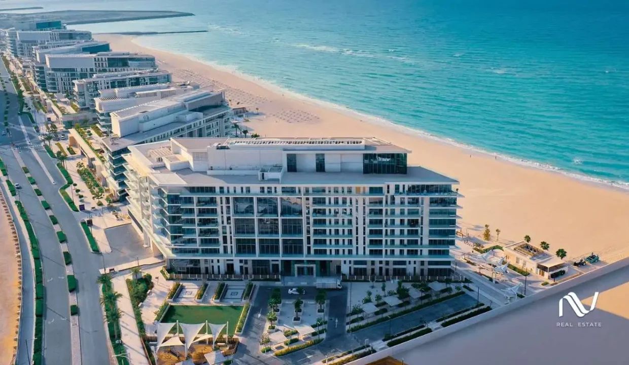 Aerial view of Mamsha Al Saadiyat showcasing luxury beachfront apartments with a pristine sandy beach